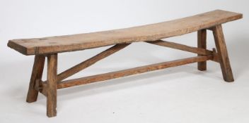 Rustic pine country bench, having a thick single plank seat raised on square legs united by