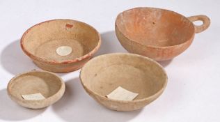 Roman pottery, three bowls, together with a redware bowl with loop handle, 10cm diameter to 16.5cm