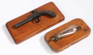 A George III percussion pistol, in relic condition, mounted, together with a copper powder flask,