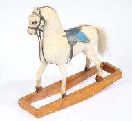 Victorian miniature wooden rocking horse, painted in white with blue leather saddle, 51cm long, 46cm