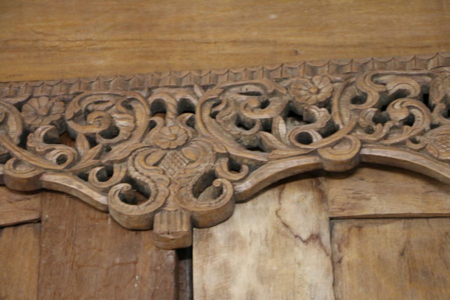 A pair of substantial Indonesian doors and frame, the scroll, carved pediment above a pierced scroll - Image 3 of 3