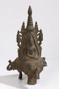 A 19th Century  bronze figure of Buddha, possibly Nepal, raised on a three elephant masks, 31cm