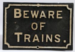 Cast iron sign 'Beware of Trains', in white lettering on black ground, 55.5cm wide, 37.5cm high