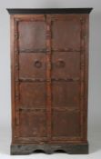 Rajasthan teak cupboard, the pair of panelled doors with iron straps and loop handles, enclosing two