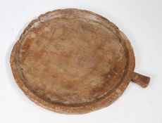 Large fruitwood serving board, of circular form with handle, 74cm diameter