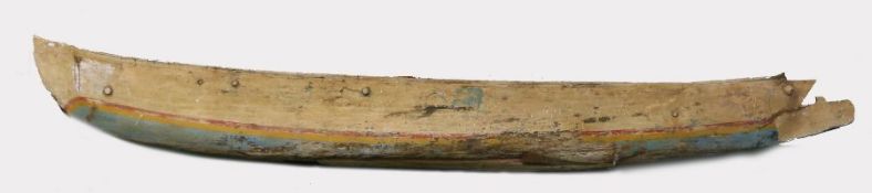Indonesian Jukung wooden canoe, the bow carved with a face mask, with blue, yellow and red painted