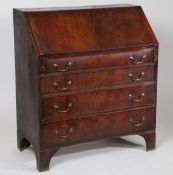 George III mahogany bureau, the sloping fall enclosing an interior with small drawers, fitted four