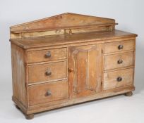 Victorian pine sideboard, having arched gallery above an arrangement of six drawers and centred with