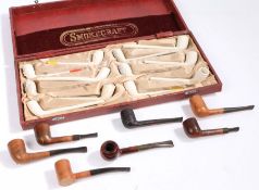 A collection of clay pipes, within the Smokecraft case, together with some wooden pipe, (qty)