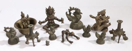 A collection of Indian bronzes, to include figural examples, Buddha, weights and a pair of candle