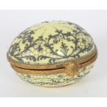 Le Tallec porcelain egg shaped trinket box with raised decoration on a yellow ground, gilt mounts,