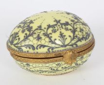 Le Tallec porcelain egg shaped trinket box with raised decoration on a yellow ground, gilt mounts,