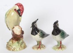 A Beswick pottery model of a Green Woodpecker (No 1213) and two Beswick Lapwings (No 2418) (3)