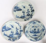 Three 18th Century English Delft chargers, to include a near pair in blue decoration with a Oriental