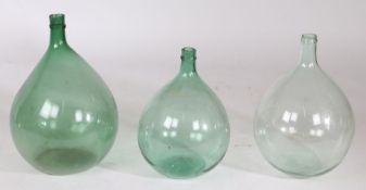 Three French claret flasks, to include two olive green and a clear example, 45cm high. 50cm high and