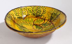 A large 19th Century French bowl, in mustard yellow glaze and brown and green leaf slip with a