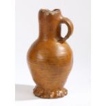 A 16th Century German jug, brown glaze with a ribbed body and loop handle, restorations, 23.5cm