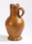 A 16th Century German jug, brown glaze with a ribbed body and loop handle, restorations, 23.5cm