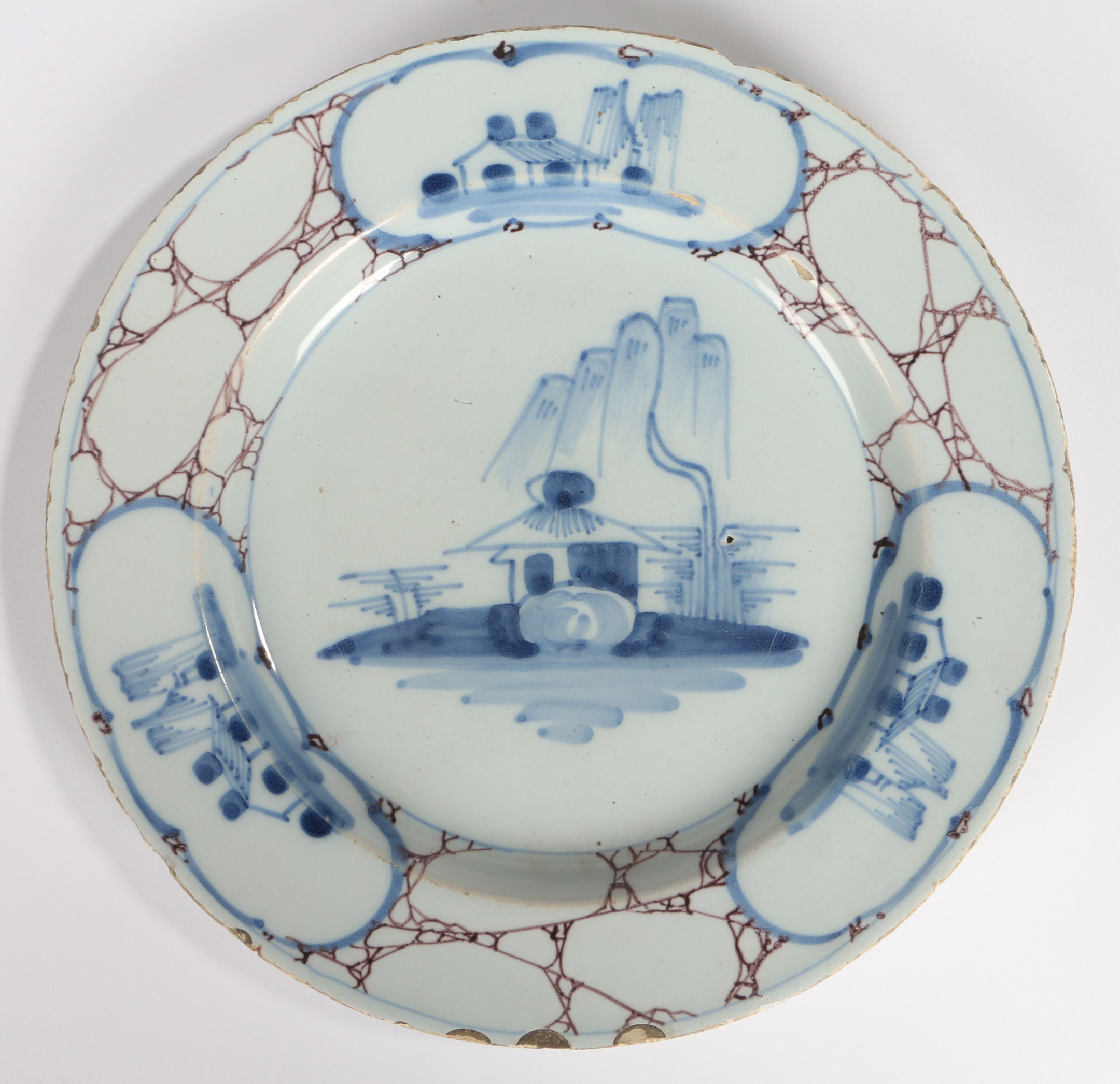 An 18th Century English Delft plate, circa 1740, with a central blue painted pagoda under a willow