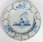 An 18th Century English Delft plate, circa 1740, with a central blue painted pagoda under a willow