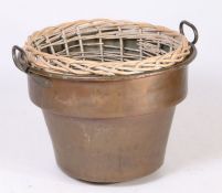 A large 19th Century copper basket, shaped from with carrying handle, with a later associated log