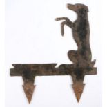 A sheet metal boot scraper, depicting a dog on its hind legs, 41cm long