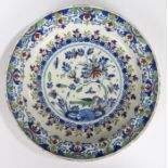 An 18th Century Delft charger, Bristol circa 1760, with a parrot below a large flower and insects
