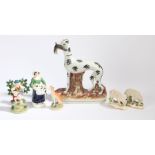 Staffordshire pottery, to include a Greyhound clutching a rabbit, a pair of sheep, a seated