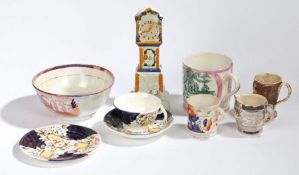 A 19th Century Staffordshire novelty money bank, as a longcase clock, together with a tea bowl,