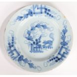 An English 18th Century Delft plate, decorated in blue with a squirrel on a branch by berries and