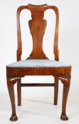 A George I walnut chair, the undulating top rail above the vase shape splat and drop in seat above