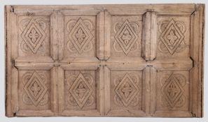 A 17th Century oak panel, eight carved panels as lozenges and lunettes, 85cm wide, 147cm high
