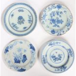 Four 18th Century Delft plates, each with foliate decoration in blue, 22cm diameter to 23.5cm