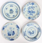 Four 18th Century Delft plates, each with foliate decoration in blue, 22cm diameter to 23.5cm