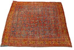 A Large Ushak rug, set with Herati motifs, with a boteh motif to the borders, on a red orange and