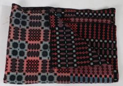 A Welsh blanket, with a pink, blue and black geometric design, 150cm x 200cm approximately