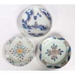 Three 18th Century English Delft dishes, the first painted in blue with a central figure and a