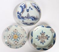 Three 18th Century English Delft dishes, the first painted in blue with a central figure and a