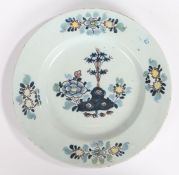 An 18th Century English Delft plate, circa 1760, with blue, purple, yellow and green foliate