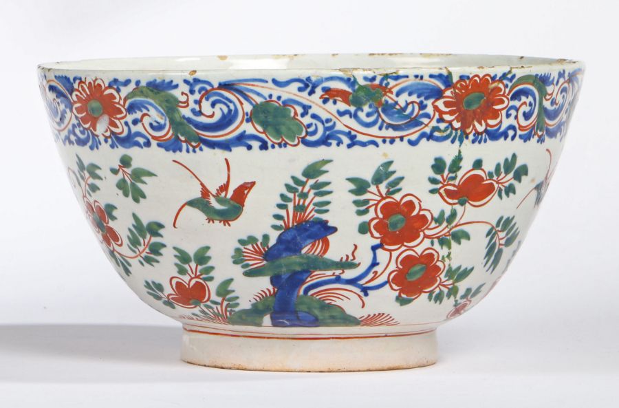 An 18th Century Delft punch bowl, polychrome decorated with flowers and birds, 25.5cm diameter, 14cm