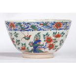 An 18th Century Delft punch bowl, polychrome decorated with flowers and birds, 25.5cm diameter, 14cm