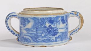 An 18th Century Delft twin handled posset, decorated with an Oriental landscape scene, lacking the