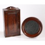 A George III oak candle box, with a fielded panel slide front, 38cm high, 20.5cm wide, together with