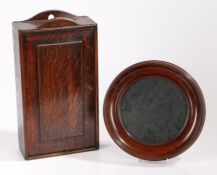 A George III oak candle box, with a fielded panel slide front, 38cm high, 20.5cm wide, together with