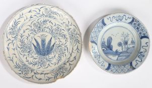 An 18th Century Delft dish, with a flower and leaf design, 22.5cm diameter, together with another