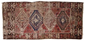 A Persian Kilim, set with animal motifs, diamond lozenges and various guls, with a red blue and