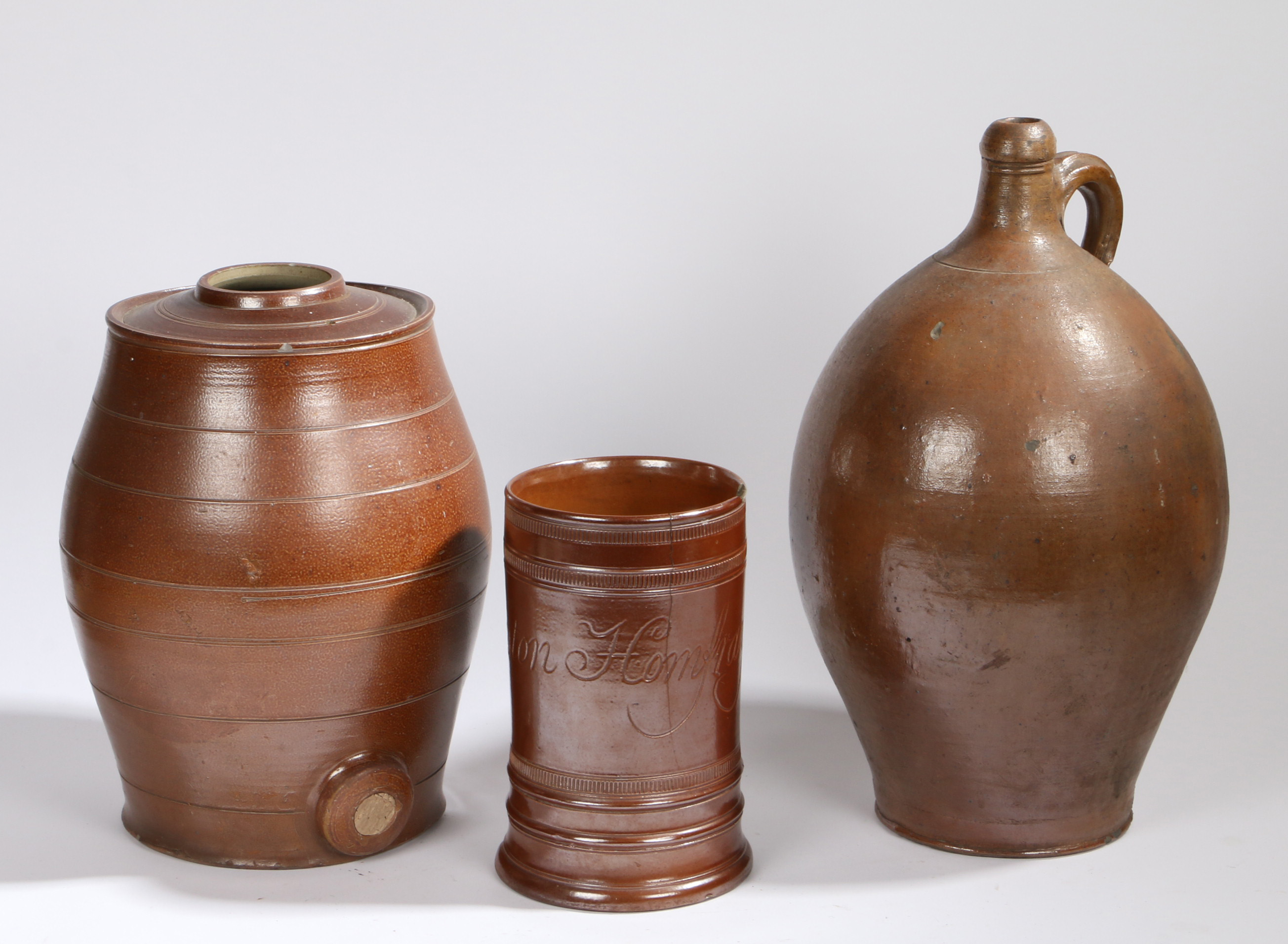 A large 19th Century brown glaze jug, in the Bellarmine form, 47cm high, together with a pottery - Image 2 of 2