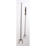 An 18th Century steel toasting fork, with three prongs and a flattened handle with etched design,