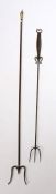 An 18th Century steel toasting fork, with three prongs and a flattened handle with etched design,