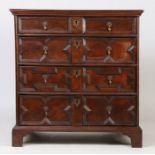 A Charles II oak geometric chest of drawers, circa 1680, the rectangular top above four long drawers